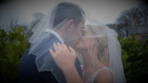 Veil kiss between bride and groom at their south west wedding venue