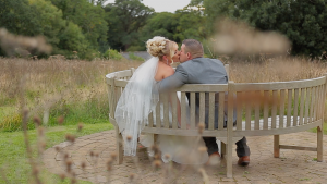 Couple sat on bench after getting legally married which they planned during their wedding planning process