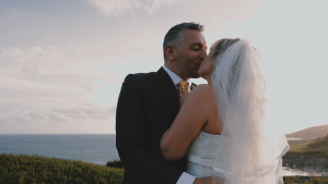 Bride and Groom coastal kiss during wedding video in Devon