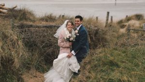 Bride & Groom kissing on a beach in Cornwall