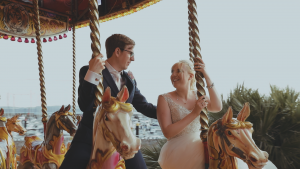 Bride & Groom on a Merry go Round in Torquay captured by south west wedding videographer
