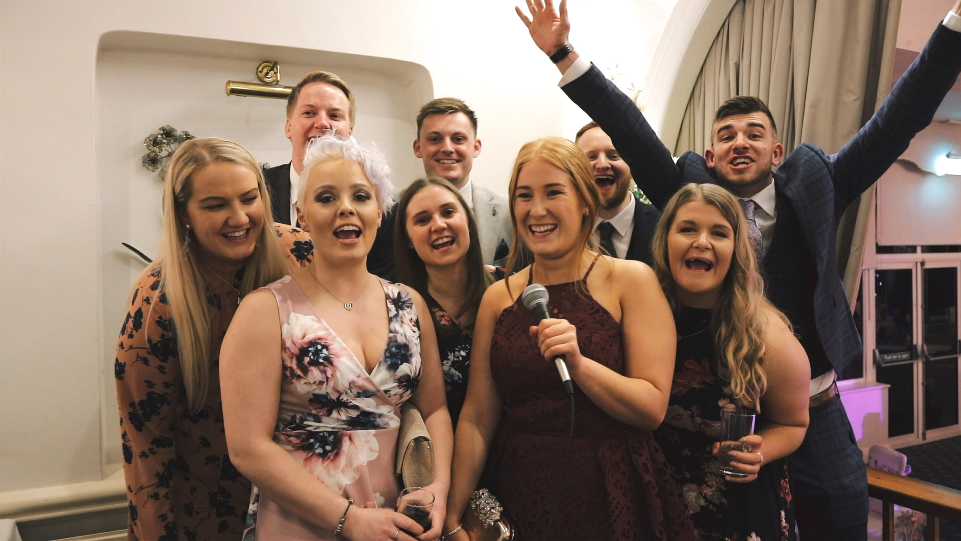 Wedding Guest Messages Guests filming video messages for the bride and groom at Moorland Garden Hotel in Devon during the evening wedding reception