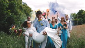 Wedding party smoke bombs as wedding videographer and photographer work together to capture their day