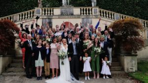 The whole wedding party and guests cheering for the videographer at Mount Edgcumbe captured by South west wedding videographer