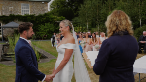 Couple holding hands at their outdoor wedding ceremony 