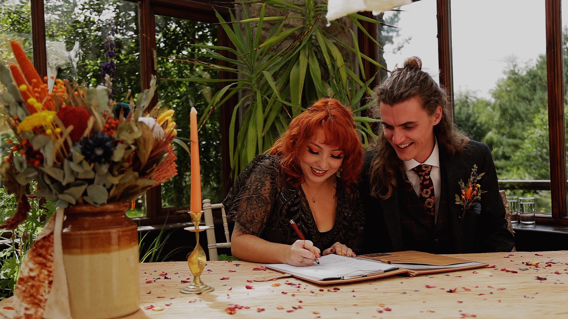 A non traditional bride & groom signing their marriage certificate at Westcott Barton