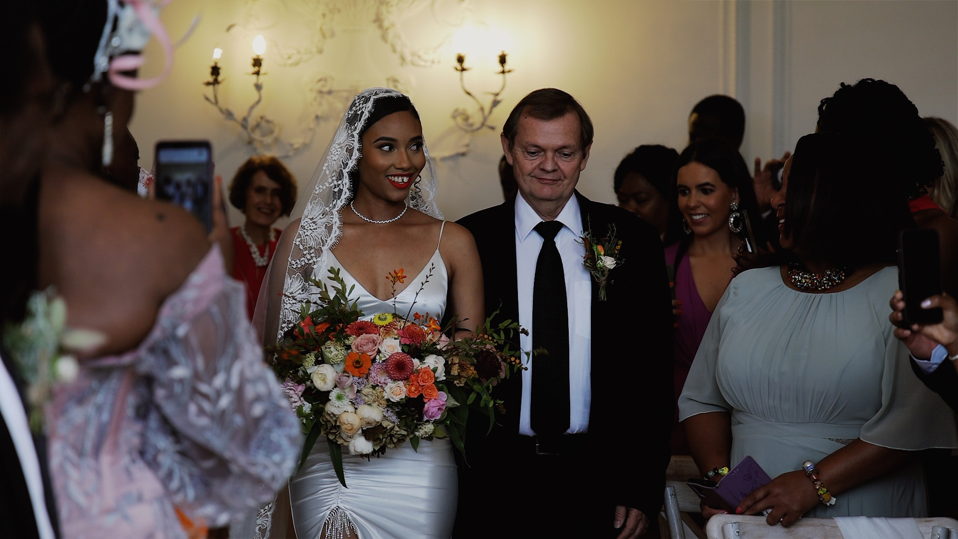 A father escorts his daughter down the aisle at Rockbeare Manor