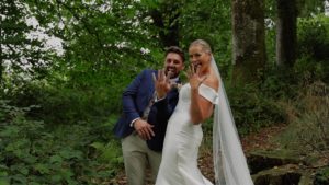 Bride and groom showing off their wedding rings in capture from cinematic wedding film