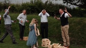 A capture of guests playing garden games from personalised wedding video