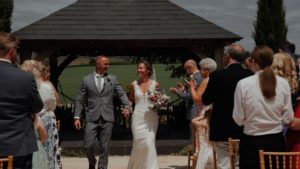 Couple walking down aisle at their outdoor wedding ceremony