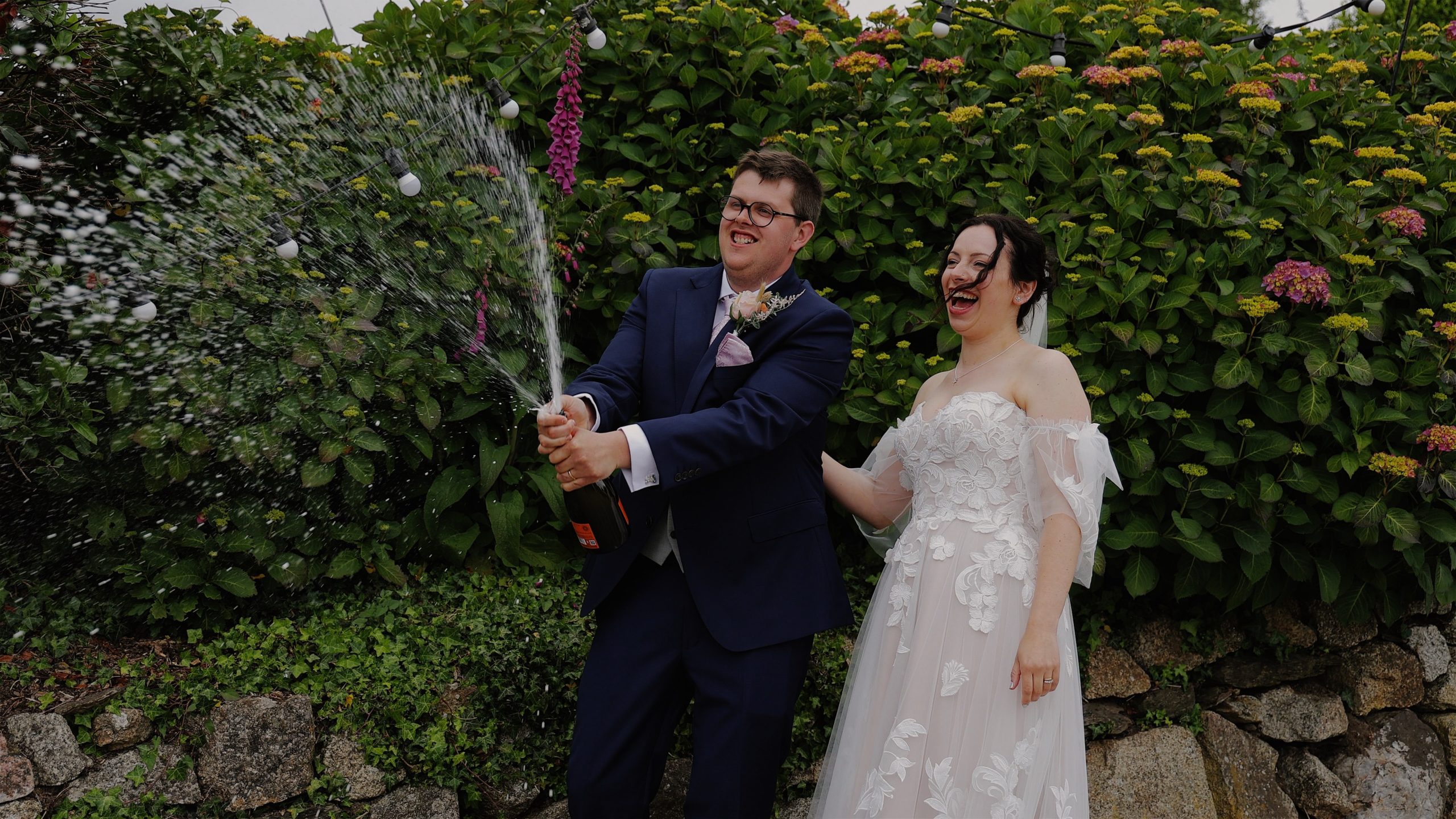 Bride & Groom celebrate with a champagne spray at Tregedna Farm