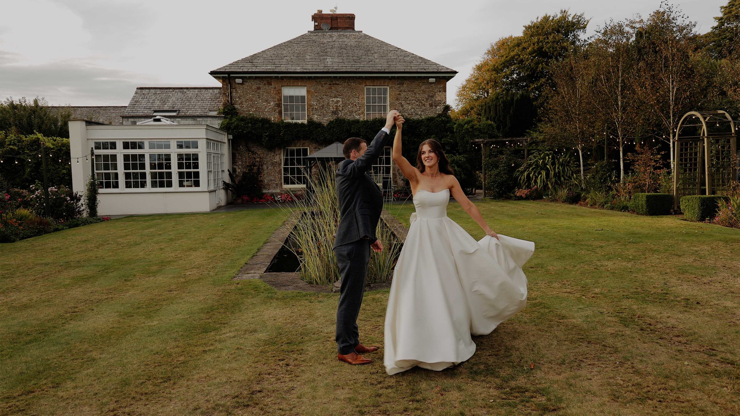 Chloe & Tom Glebe wedding barn dress spin A smiling groom carrying his bride through a forest