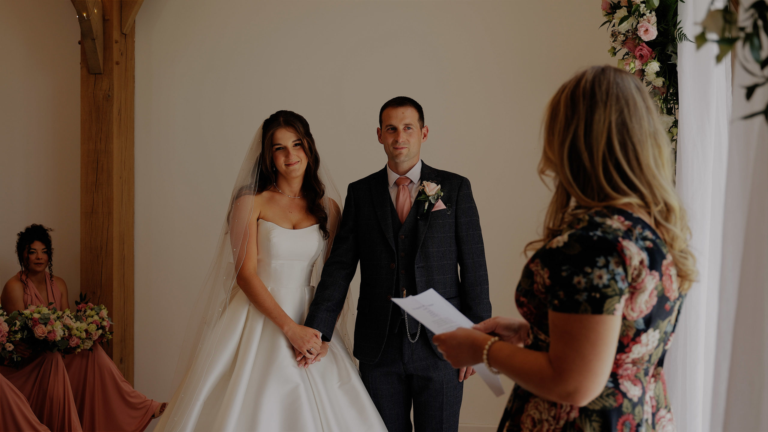 Bride & groom wearing sunglasses punching their air with joy at Harefield Barn