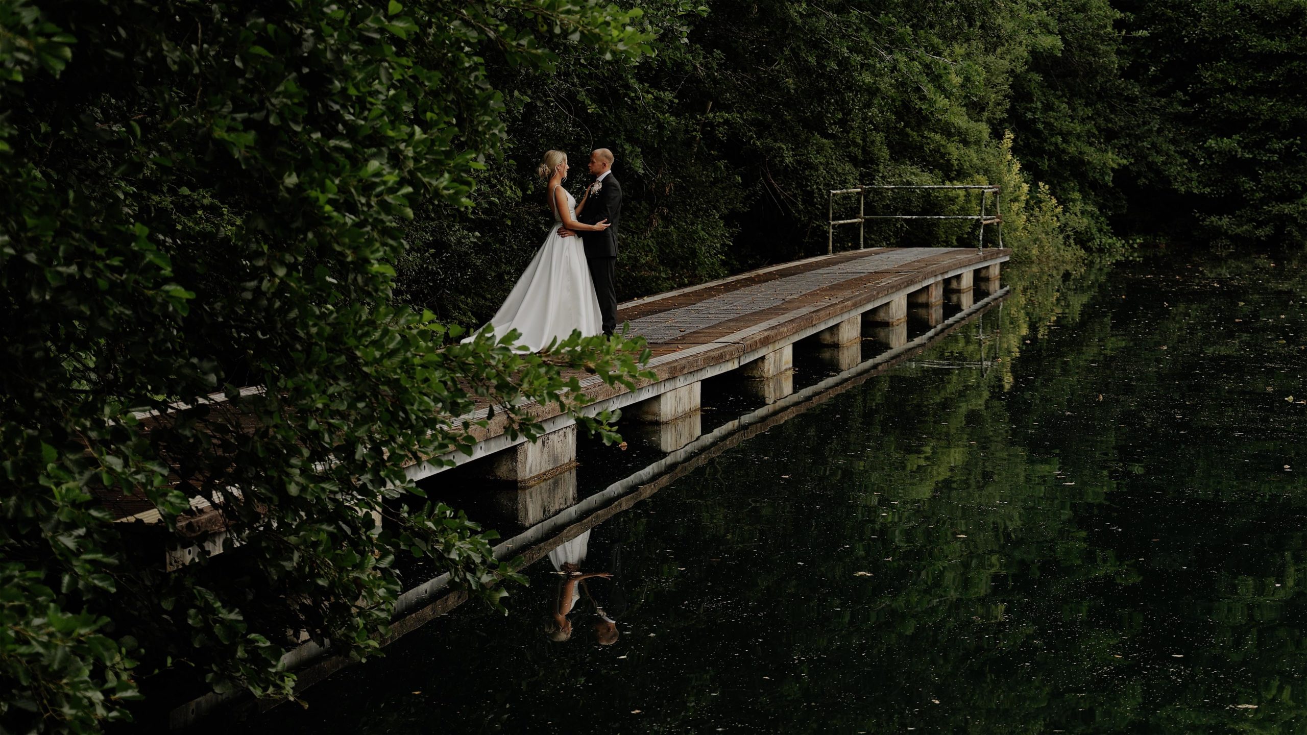 A bride and groom going for a walk with their dog along a country lane at Trevenna Barns