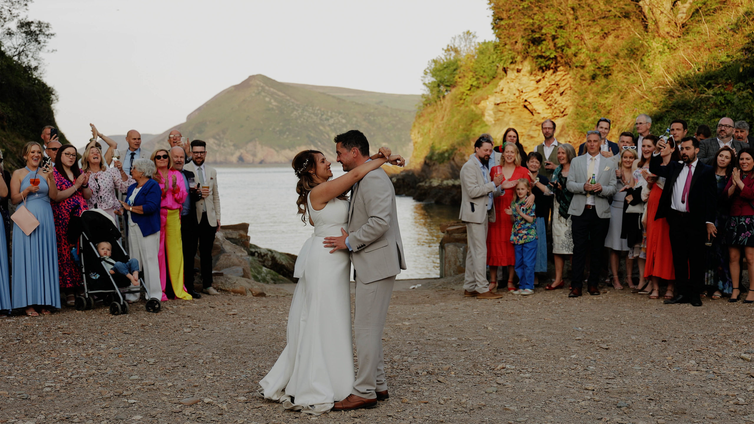 Zoe & Dan watermouth cove beach first dance A bride and her bridespeople gathered around to give the bestdog a fuss at Trevenna Barns